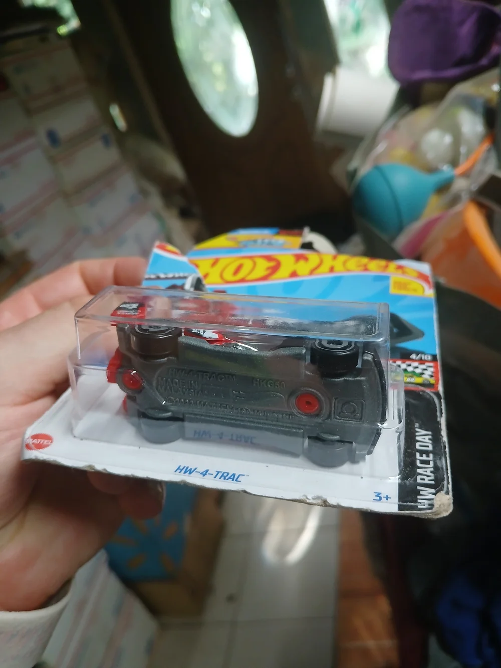 1:64 scale red and black HW-4-TRAC die-cast car from the 2024 Hot Wheels HW Race